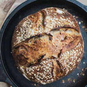 a cast iron with oat bread in it