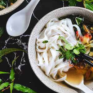 a bowl of soup with rice noodles