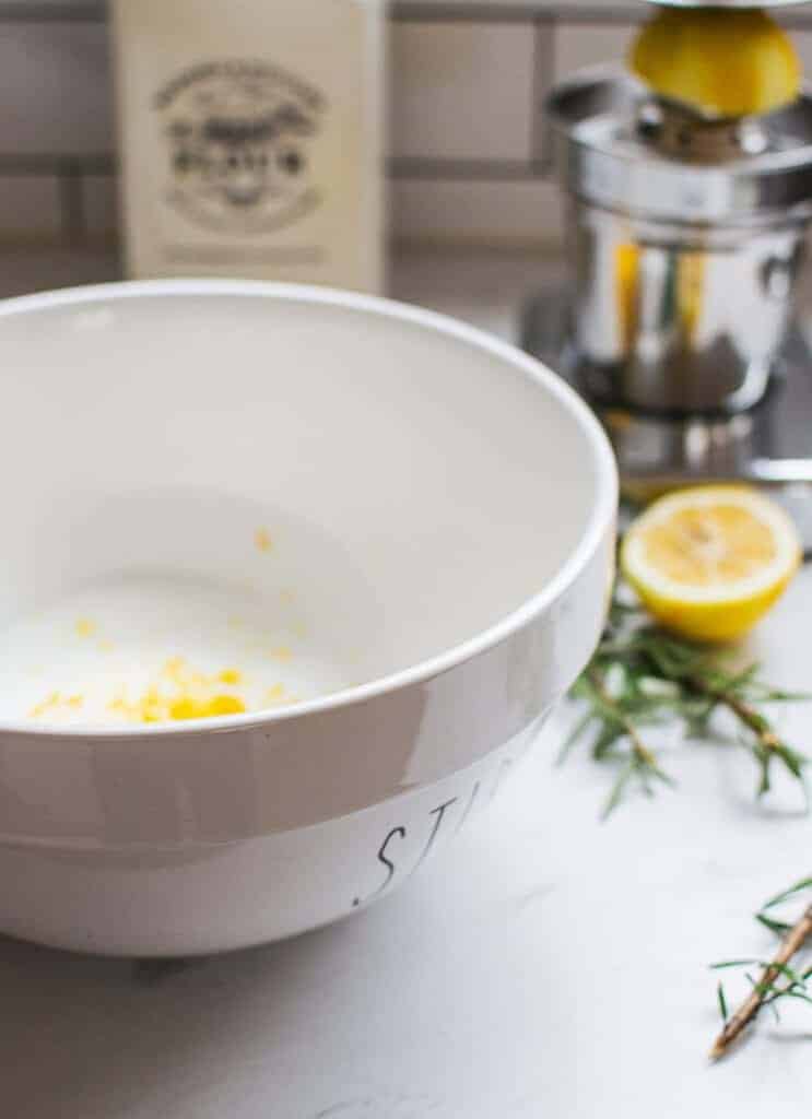 a white bowl with lemon zest in it