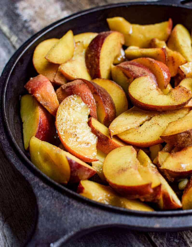 close up of sliced peaches in a skillet 