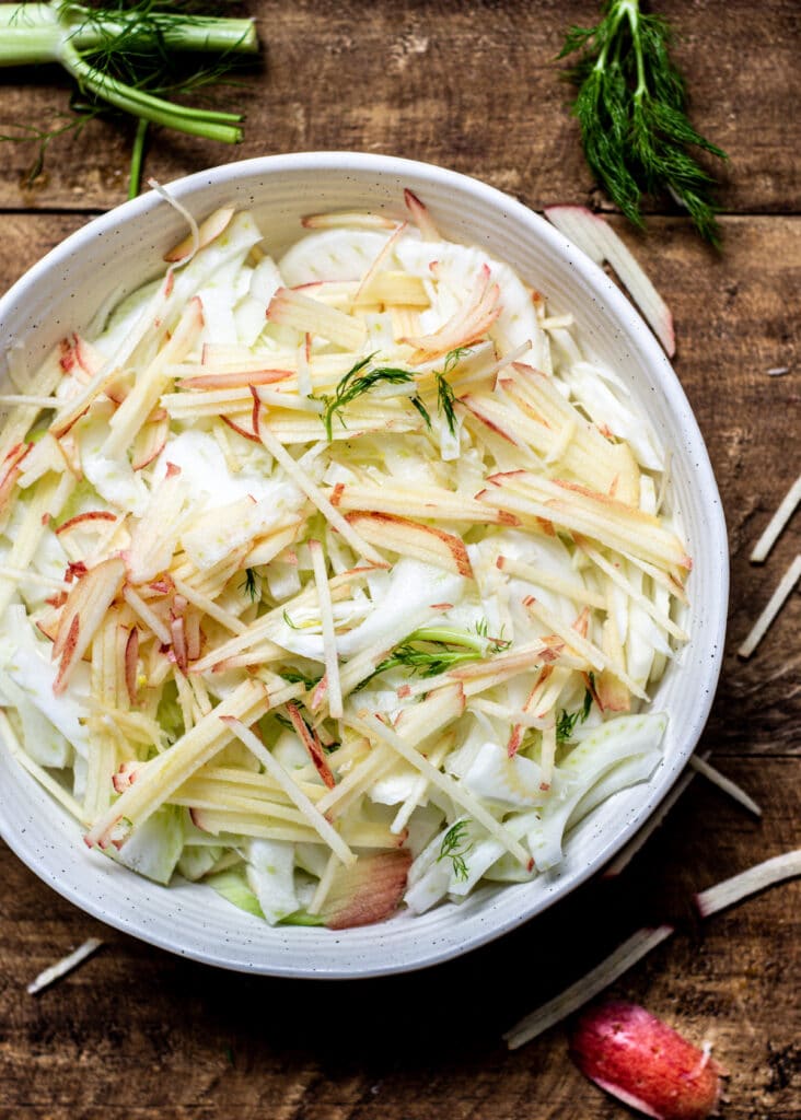 apple and fennel slaw in a white bowl
