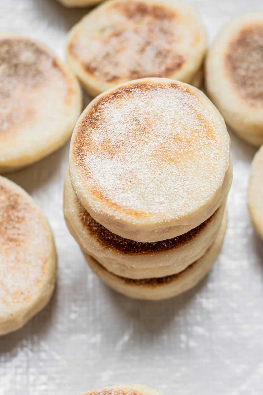 stacked English Muffins on white plate.