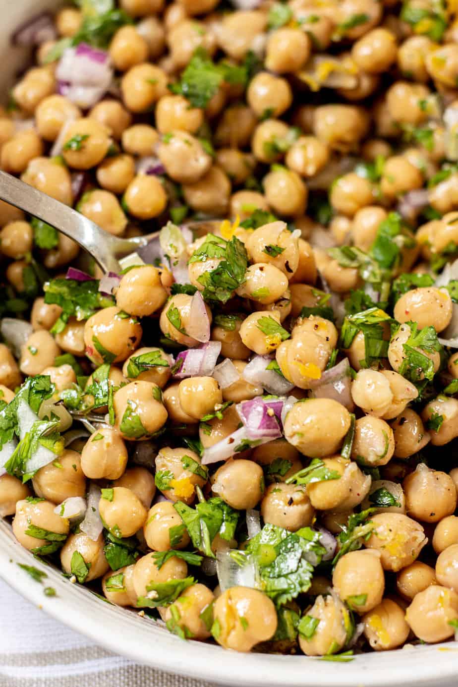 a spoon with chickpea salad.