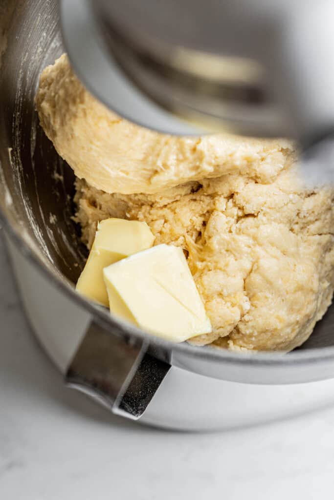 dough with butter cubes in mixer.