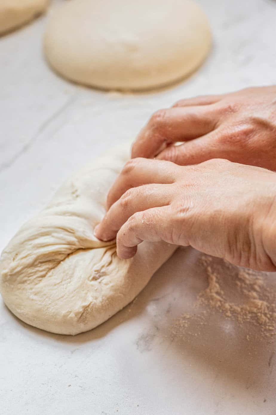 hand pressing dough.