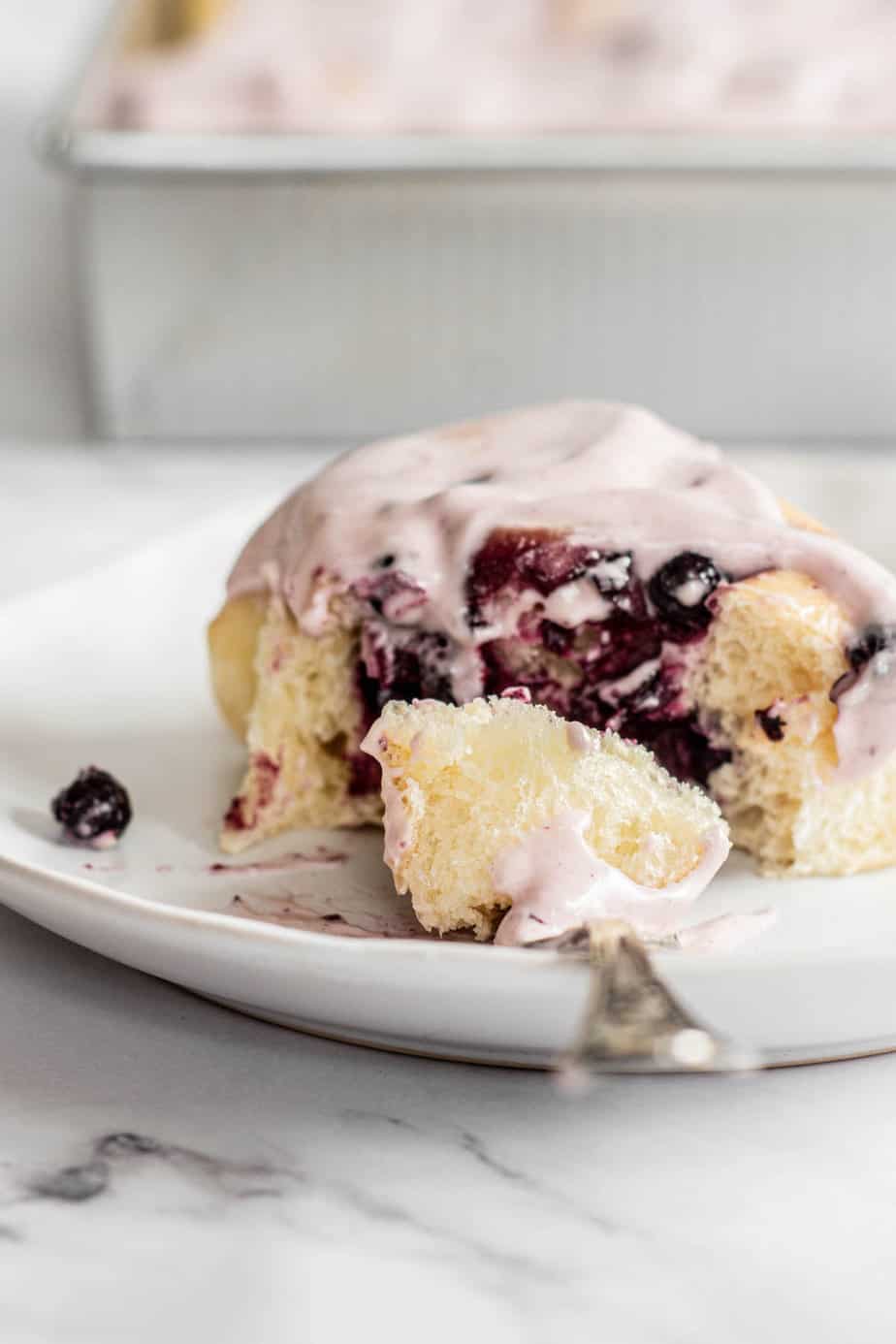 Sourdough blueberry rolls with fork.