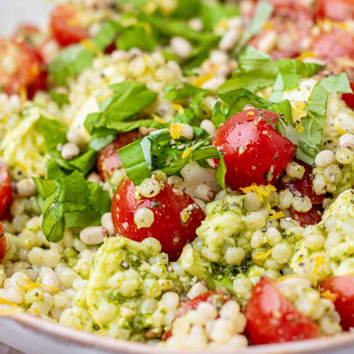 close up of chopped tomatoes and basil and couscous.