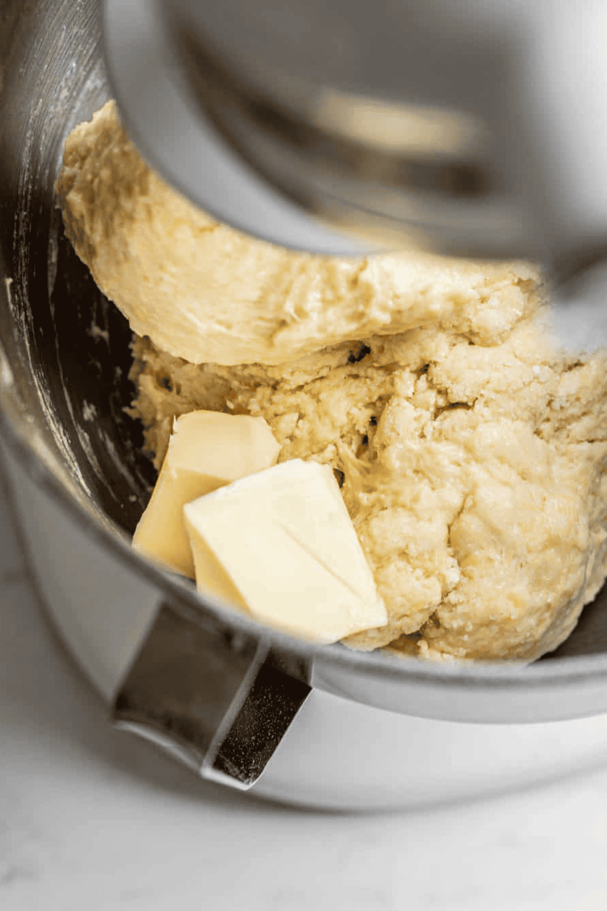 butter cubes on dough.