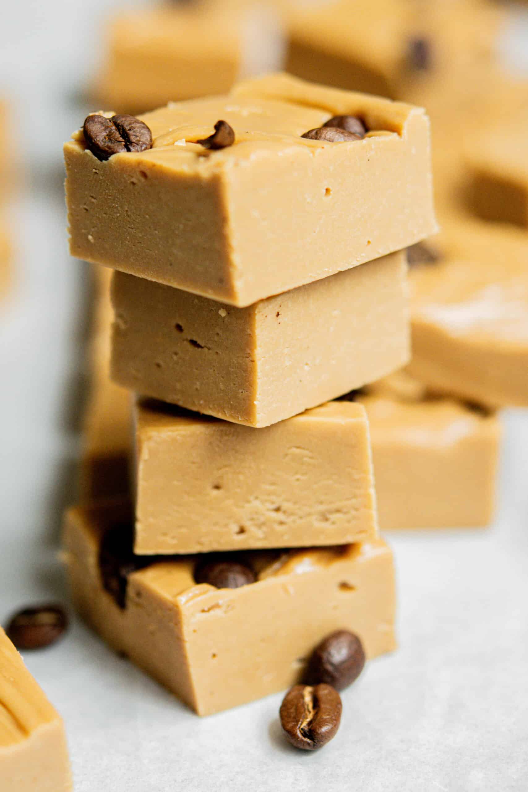stacked coffee fudge pieces with coffee beans on them.